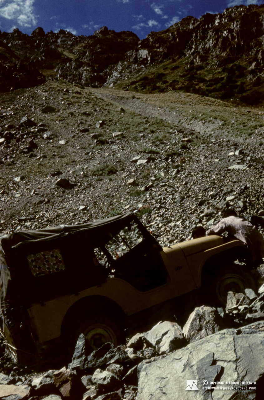 Porters riding on jeeps.